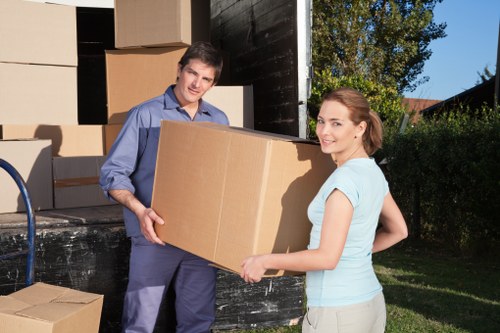Professional man with van handling belongings carefully